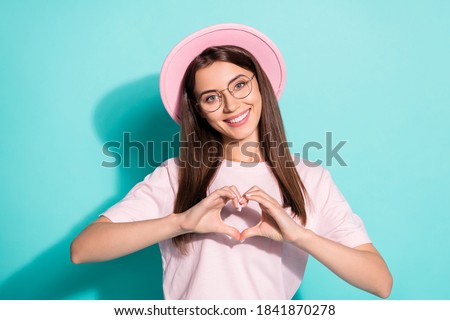 Photo of positive cheerful young lady make fingers heart show endless love symbol isolated on turquoise color background