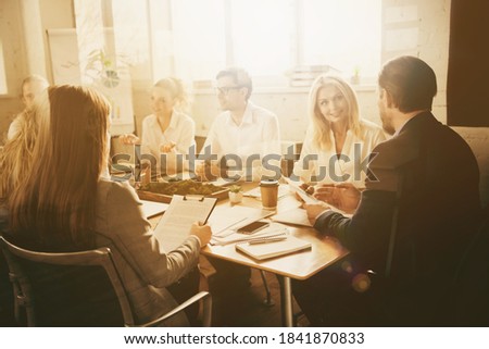 Photo partners investors man woman sit table have way-out crisis company development strategy briefing tell talk say speak cost economy reduction solution in boardroom workplace workstation