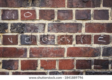 old brick wall with go veggie message