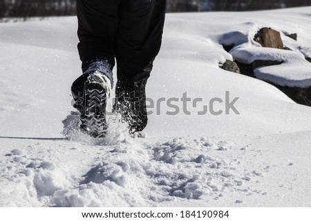 Man walking in the snow Royalty-Free Stock Photo #184190984
