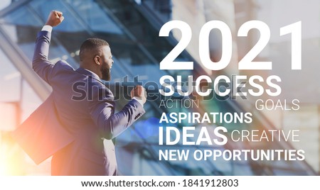 2021 Year Of Business Success. Joyful African Businessman Shouting Shaking Fists In Joy Celebrating Successful New Year Standing In Urban Area Outdoor. Panorama, Motivational Collage With Wordcloud Royalty-Free Stock Photo #1841912803