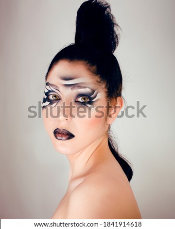 beauty young woman with creative make up like zebra closeup, waves on face