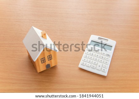 House model and calculator. The concept of buying a house.