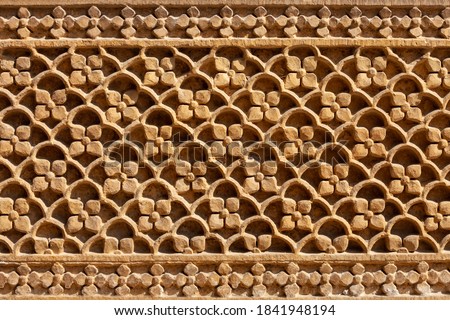 Rajasthani floral style haveli carving pattern in old building in Jaislamer city in Rajasthan state of India Royalty-Free Stock Photo #1841948194