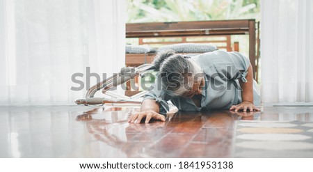 Asian senior woman falling down on lying floor at home after Stumbled at the doorstep and Crying in pain and asking someone for help. Concept of old elderly insurance and health care Royalty-Free Stock Photo #1841953138