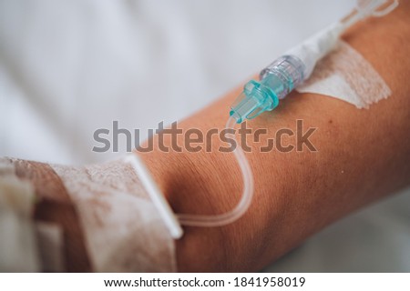 Patient's hand with Total Parenteral Nutrition (TPN) being administered into vein Royalty-Free Stock Photo #1841958019