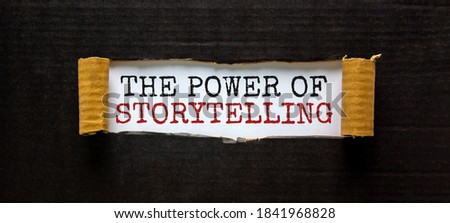 The words 'the power of storytelling' appearing behind torn black paper. Beautiful background. Business concept.