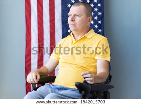 American freedom in wheelchair with USA flag