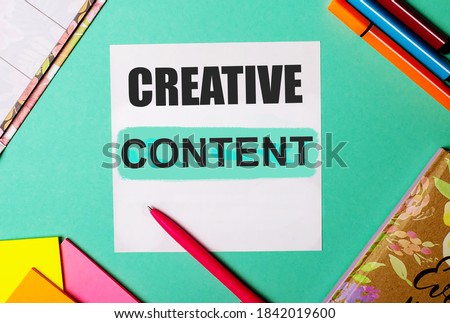 CREATIVE CONTENT written on a turquoise background near bright stickers, notepads and markers