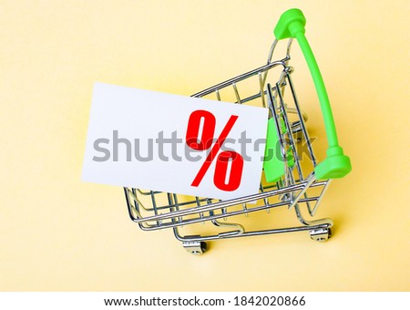 The card with a percent sign is in the shopping cart. Place to copy text or graphics. Marketing concept