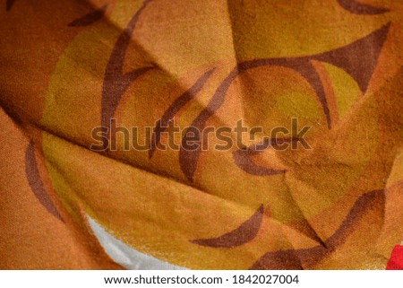 yellow orange fabric with patterns on it