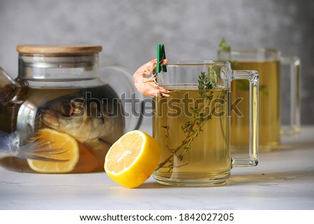 herring and shrimp tea with lemon is on the table	