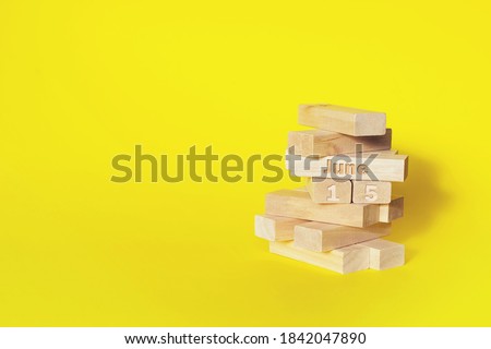 June 15th. Day 15 of month, Calendar date. Wooden blocks folded into the tower with month and day on yellow background, with copy space. Summer month, day of the year concept