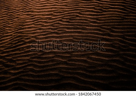 Dark gold colored shaded sands of the desert. Background and texture for modern design