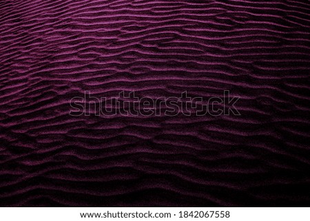 Pink-violet colored shaded sands of the desert. Background and texture for modern design
