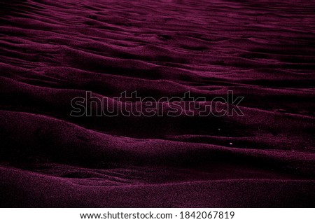 Pink-violet colored shaded sands of the desert. Background and texture for modern design
