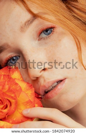 Fashion photo woman extended colored fake eyelashes for red haired with rose flower face.