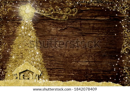 Christmas Nativity Scene and tree, religious greetings cards. Abstract freehand drawing of Nativity Scene and  Christmas tree with gold glitter on old wooden table with copy space. Royalty-Free Stock Photo #1842078409