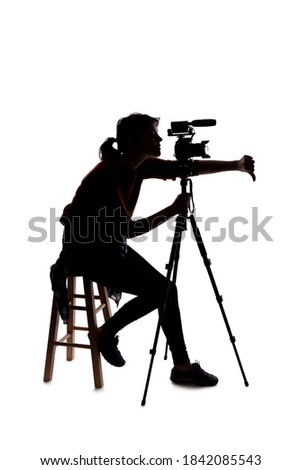 Silhouette of a female indie filmmaker, online content creator or casting director with a camera and mic okking stressed out