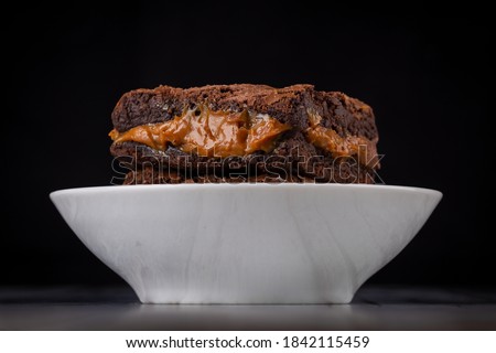 Chocolate brownie with milk powder delicious filling. Closeup photography.