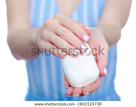 Woman holding white soap in hand on white background isolation