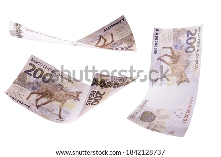 two hundred reais banknotes from brazil falling on isolated white background, new banknote from brazil