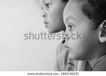 little boy looking straight ahead on white background stock photo