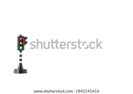 toy traffic light with all three lights lit on white background