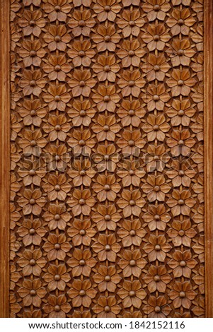 Wood background close-up. Unique  design of a tree. Structure  drawing of wood background. Orange wood background. Close- up. Brown wallpaper. Details of a wood door.