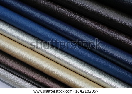 Samples of leatherette in different shades top view. Artificial leather color palette catalog. Eco leather in blue, black, white, background. Royalty-Free Stock Photo #1842182059