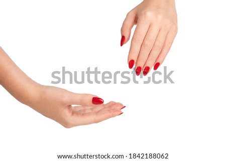 Female Hands of a beautiful well-groomed woman with feminine red nails on a white background. Isolate. Manicure, pedicure beauty salon concept. Empty space for text or logo. gel polish