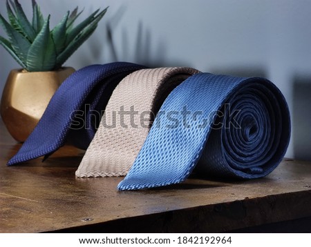 Perfect necktie close up. Shopping concept. Personal stylist service. Stylist advice. Matching necktie with outfit. Pick necktie. Different blue color necktie. Menswear clothes and accessories. Royalty-Free Stock Photo #1842192964