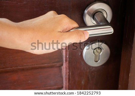 Hand operates on door handle, stock photo