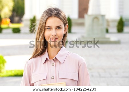 Close up portrait of a young beautiful blonde woman in summer park