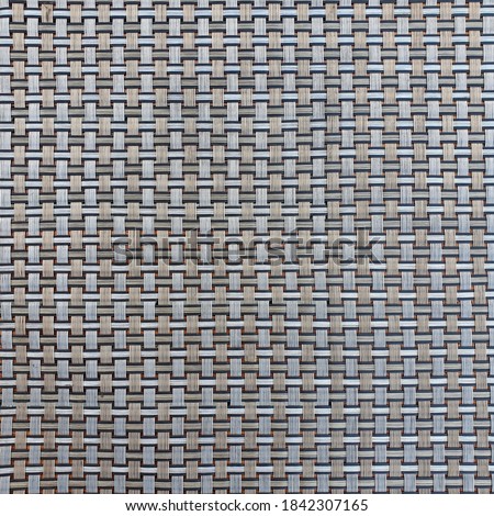 Wickerwork patterns woven from rattan - Plastic fiber - yarn or metallic silver and gray. Suitable for making background pictures. weaved gray pattern

