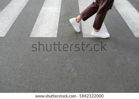 
female feet crossing the crosswalk