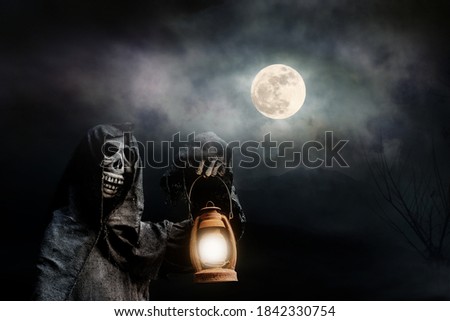 Ghost doll holding a lamp  with full moon background