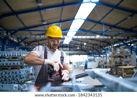 Working in factory assembling parts in production line. Royalty-Free Stock Photo #1842343135