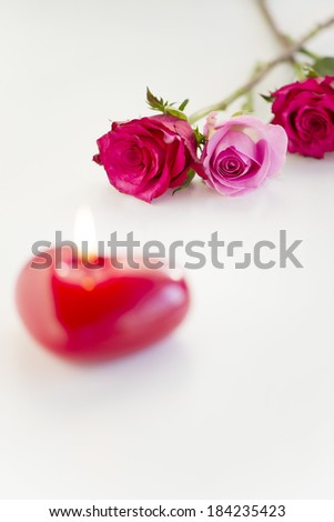 An image of Candle and roses