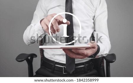 Businessman holding tablet computer with Information symbol.