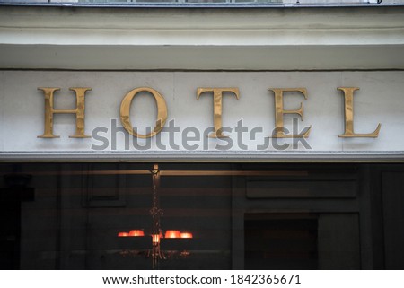 Closeup of golden luxury Hotel sign on building facade in the street