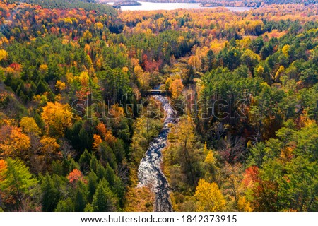 Aerial view of Winding River Through Autumn Trees with Fall Colors in Adirondacks, New York, New England