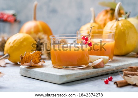 hot pumpkin punch or sangria in a glass with apple. Halloween and Thanksgiving beverage. Traditional autumn, winter drinks and cocktails