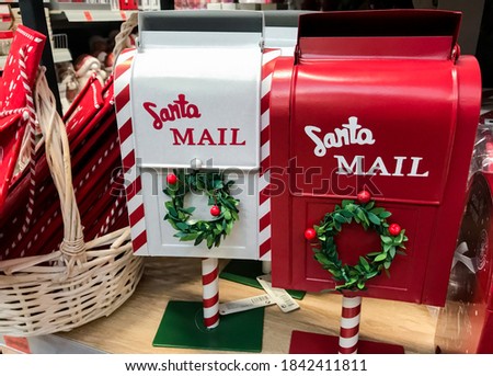 Santa Mail. Red and white mailboxes with green wreaths for letters to Santa Claus. Christmas decorations.