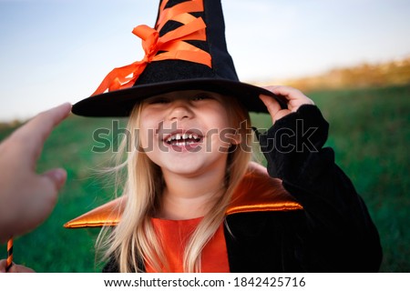 girl dressed as a witch celebrates halloween. blur, selective focus