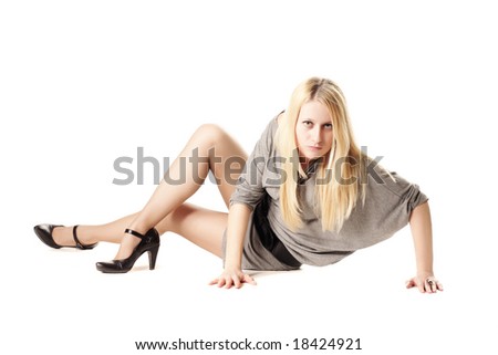 Blonde girl sitting on white floor looking to camera