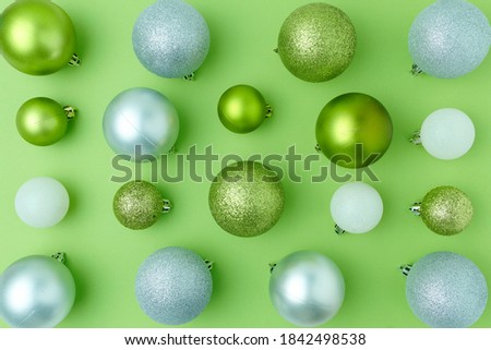 Merry Christmas. flat lay with christmas balls on green background.