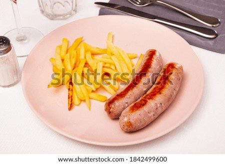 Image of tasty fried meat sausages served with french fries, nobody