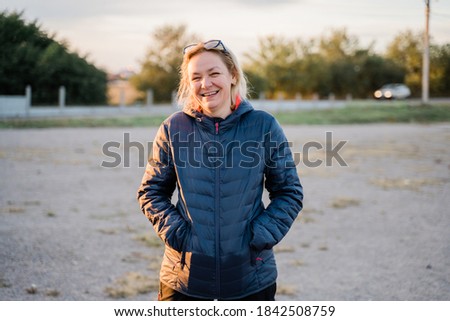 Caucasian woman outdoors traveling in cold weather. Middle aged happy people. portrait candid photo