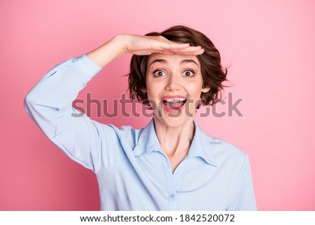 Closeup photo of attractive pretty funny lady arm forehead look far away interesting sightseeing traveling open mouth amazed wear blue office shirt isolated pink pastel color background